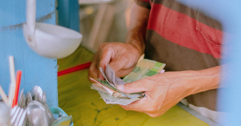 Man paying with cash in a store